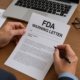 Compliance officer reviewing FDA Warning Letter response