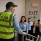 Floor warden guiding office workers during emergency evacuation
