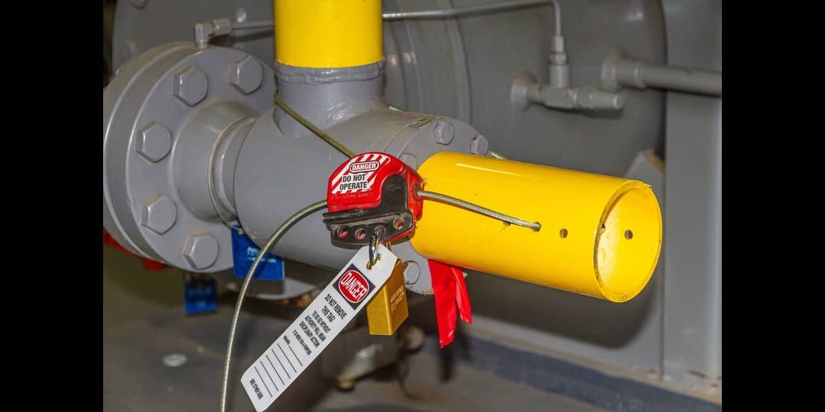 Construction worker applying lockout/tagout on electrical panel