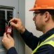 Worker applying lockout tagout device on electrical panel