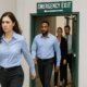 Employees evacuating through a clearly marked emergency exit