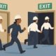 Workers safely evacuating through marked exit routes during an emergency.