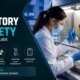Laboratory scientist in PPE working safely inside a biosafety cabinet with biohazard warning signs visible, demonstrating proper biosafety protocols and containment procedures