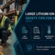 Warehouse worker inspecting large lithium-ion battery pack following safety protocols