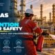 Oil and gas worker in red coveralls using a fire extinguisher on an active fire at a refinery at sunset beside a Fire Safety sign illustrating fire prevention worker safety practices including controlling ignition sources maintaining equipment and following hot work permit procedures