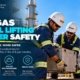 Two oil and gas workers in VelSafe hard hats and hi-vis performing a team lift of heavy equipment at a refinery with a third worker climbing a ladder with fall protection harness in the background illustrating manual lifting and ladder safety practices including proper technique team lifts ladder inspection and three-point contact